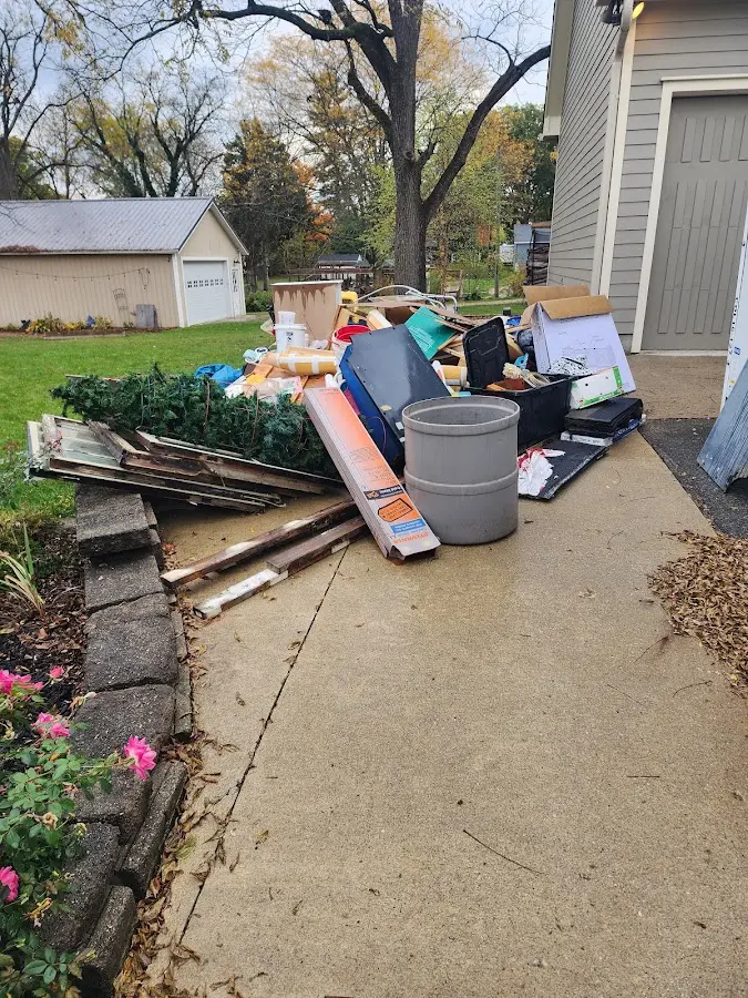 Dumpster being loaded with debris for 12 Yard Dumpster Rental in Proctor